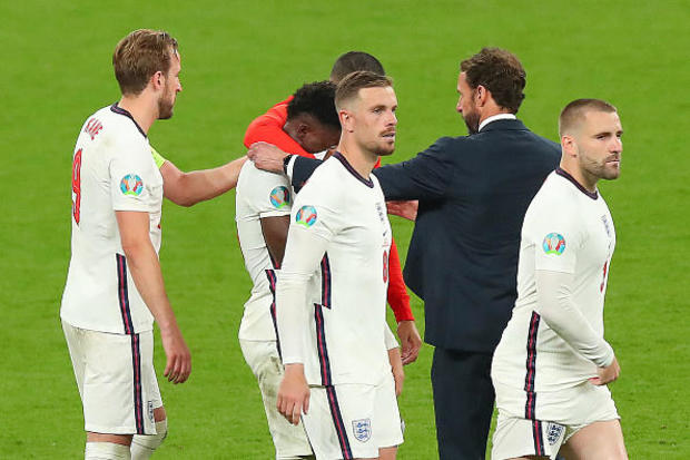 Bukayo Saka of England is consoled by teammates and Gareth Southgate, the head coach / manager of England, after missing the decisive penalty during the UEFA Euro 2020 Championship Final between Italy and England at Wembley Stadium on Sunday. / GETTY IMAGES