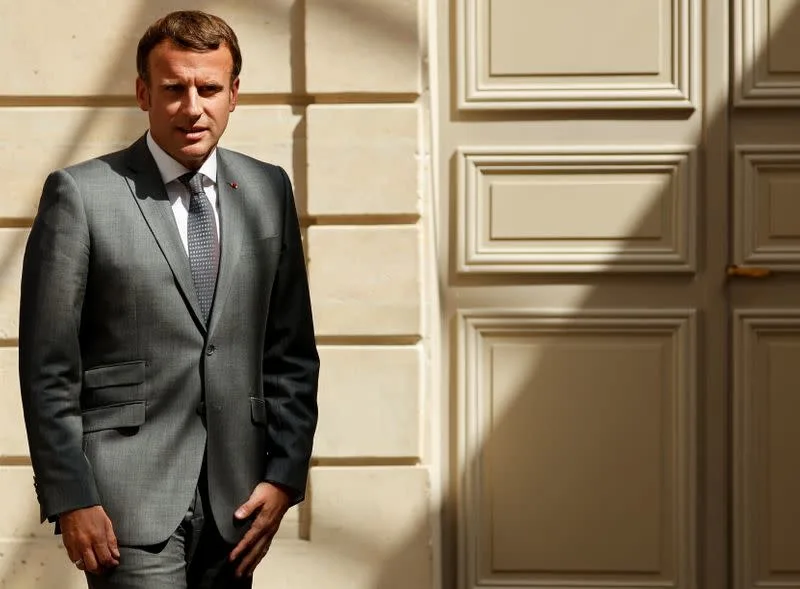 president macron in front of the door