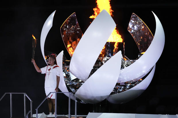 Naomi Osaka reacts after lighting the cauldron during the opening ceremony in the Olympic Stadium