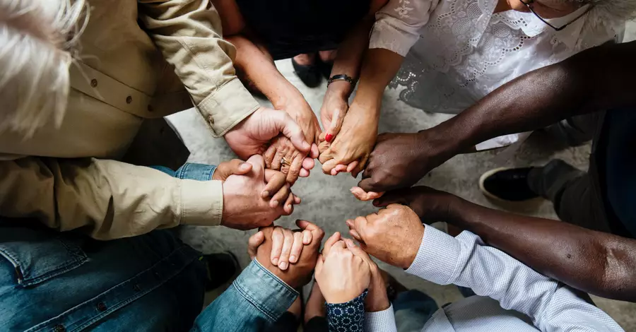 people holding hands together to pray
