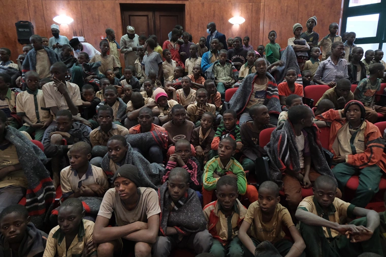 Released students gather at the Government House with other students from the Government Science Secondary school, in Kankara, in northwestern Katsina State, Nigeria, upon their release on December 18, 2020. More than 300 Nigerian schoolboys were released on Thursday after being abducted in an attack claimed by Boko Haram, officials said, although it was unclear if any more remained with their captors. | KOLA SULAIMON/AFP via Getty Images