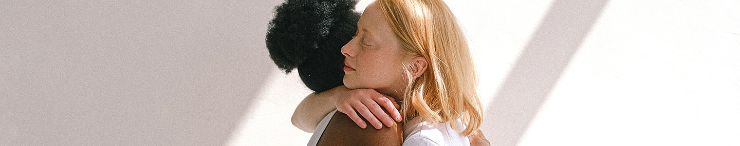 black and white woman embracing